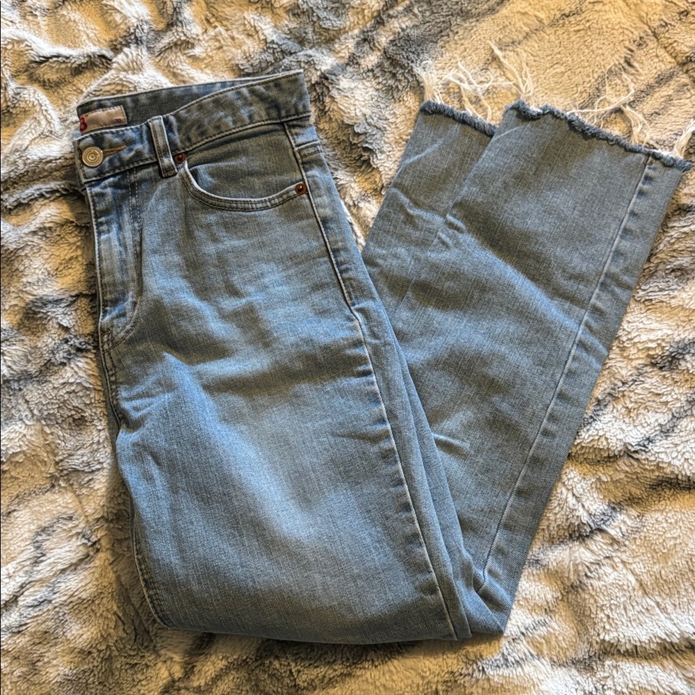 Light blue jeans with ripped knee detail
